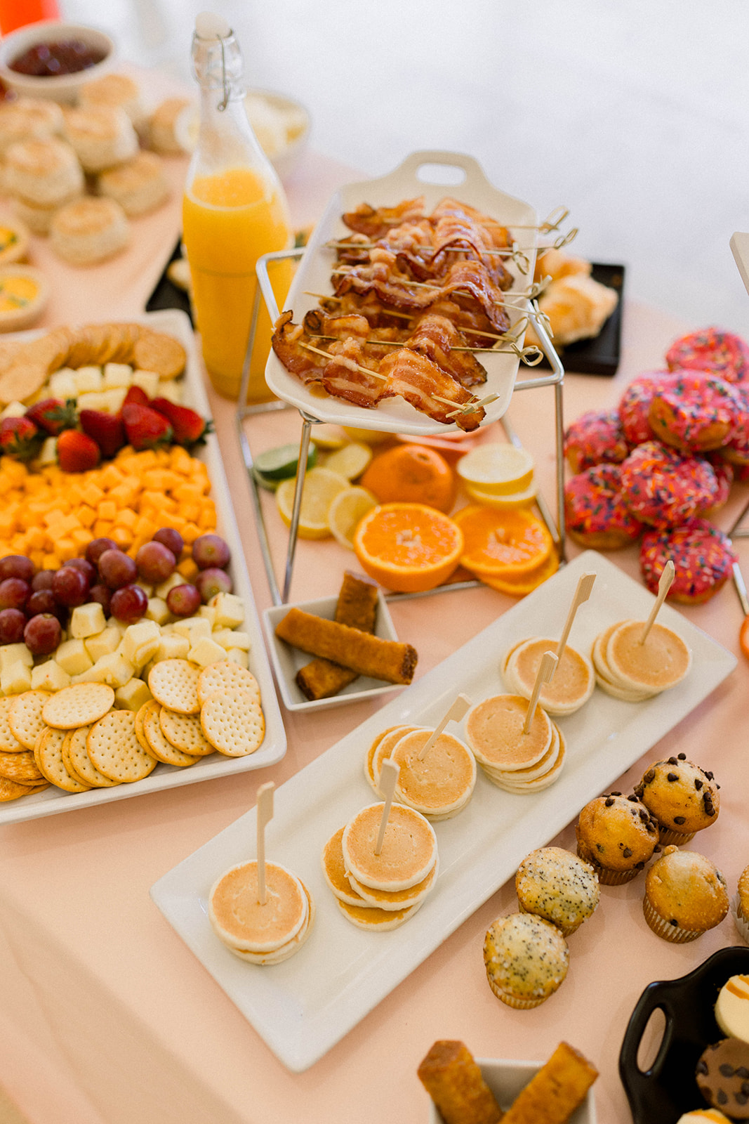 brunch grazing board with mini pancakes, fruit, bacon, and more for a wedding