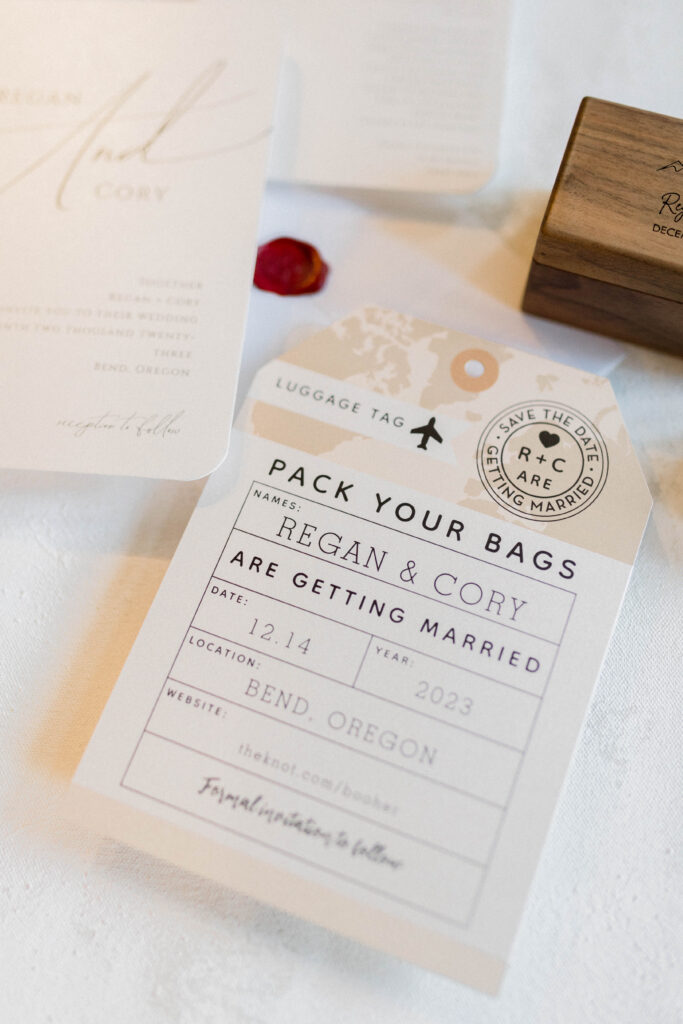 custom wedding stationery that is in the shape and appearance of a luggage tag for a destination wedding